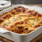 Southern-style Butter Bean Lasagna with golden melted cheese and basil garnish in a rustic baking dish.