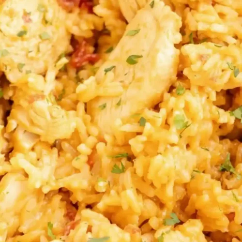 One Pot Queso Chicken and Rice: Quick and Flavorful Delight 2 Chicken and Rice dish, cooked with creamy queso and spices.